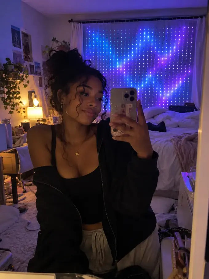 Illustrative candid bedroom phone photo with violet and blue pixel curtain lights